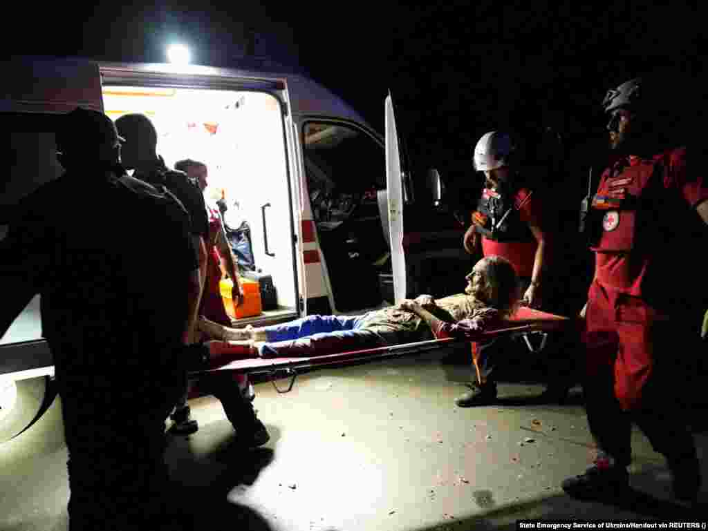 Paramedics carry a woman who was injured during the Russian missile strike in Mykolayiv. &quot;The Russians hit the city center. A garage and a three-story residential building caught fire.... A total of 18 people were injured. Nine of them were hospitalized, including five children, while two people were rescued from under the rubble. It&#39;s a miracle that we managed to save them,&quot; regional Governor Vitaliy Kim said. &nbsp;