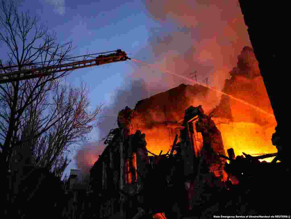 Firefighters work at the site of a three-story residential building struck by a Russian missile in Mykolayiv, southern Ukraine, on July 20. Located near the Black Sea, Mykolayiv was one of several cities targeted by missile strikes on July 20 that killed two people and injured at least 20 people, including five children, Ukrainian officials said.