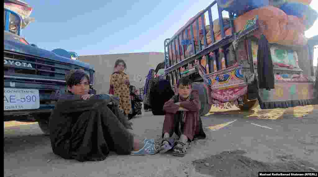 Afghans wait near trucks that will ferry them across the Chaman border crossing. Pakistani officials said the Torkham and Chaman border crossings with Afghanistan will remain open beyond their daily 4 p.m. closure to allow for those who have arrived there to leave the country.