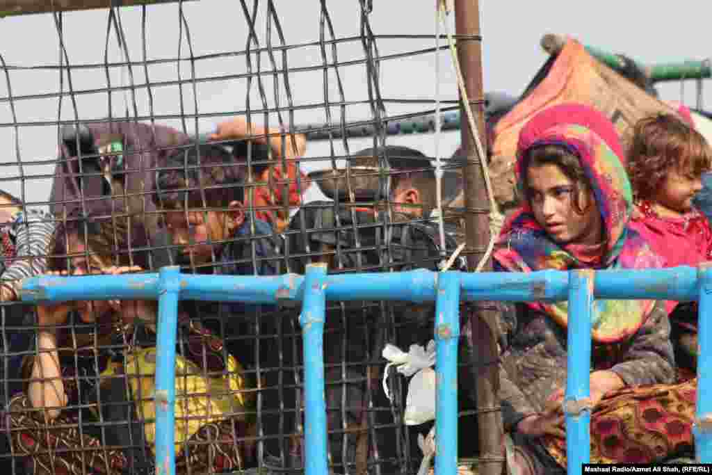 Afghan refugees arrive in trucks from Pakistan at the Afghanistan-Pakistan border at Torkham on October 31. Islamabad has resorted to threats and abuse to compel the estimated 1.7 million illegal Afghan immigrants to leave the country ahead of a November 1 deadline, Human Rights Watch (HRW) says.