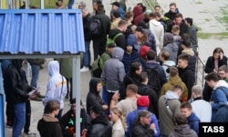 Russians wait to register at a Kazakh service center in September 2022.