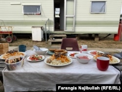 Uzbek seasonal workers in Britain prepare lunch with their traditional dish, plov.