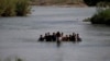 Migrants cross the Rio Grande river into the United States at Eagle Pass, Texas, in May.