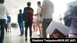 Russians wait to register at a public service center in Almaty in September 2022 after fleeing their country.