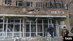 A priest stands in front of a hospital destroyed after shelling between Ukrainian forces and pro-Russian separatists in the eastern city of Donetsk on January 19.