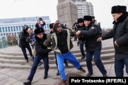 Protesters are detained in Almaty on November 20.