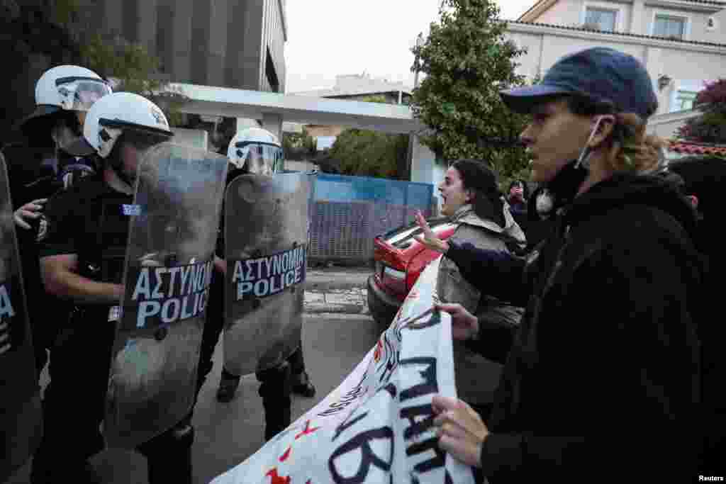 Demonstrators scuffle with riot police during an Amini protest outside the Iranian Embassy in Athens on September 22.