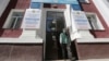 A man walks out of a building near posters informing of the upcoming referendum in Almaty, Kazakhstan, on June 1. 