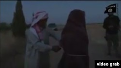 The video, whose authenticity cannot be verified, shows a young woman clad in black, with several IS militants and a man who appears to be her father. 