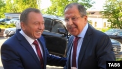 Belarusian Foreign Minister Vladimir Makey (left) and Russian Foreign Minister Sergei Lavrov shake hands as they meet for talks in Minsk on May 16.