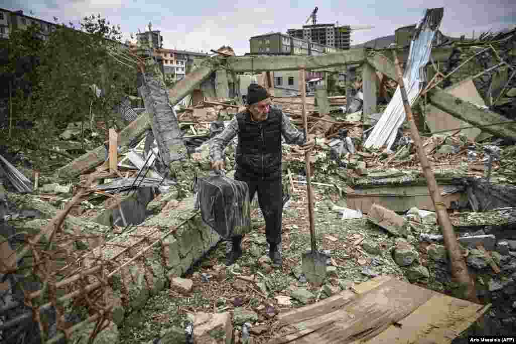 Retired Armenian police officer Genadiy Avanesian, 73, searches for belongings in the remains of his house in Stepanakert, which was hit hard by shelling on October 10. Stepanakert is the main city of Nagorno-Karabakh, with around 55,000 residents before the latest fighting.