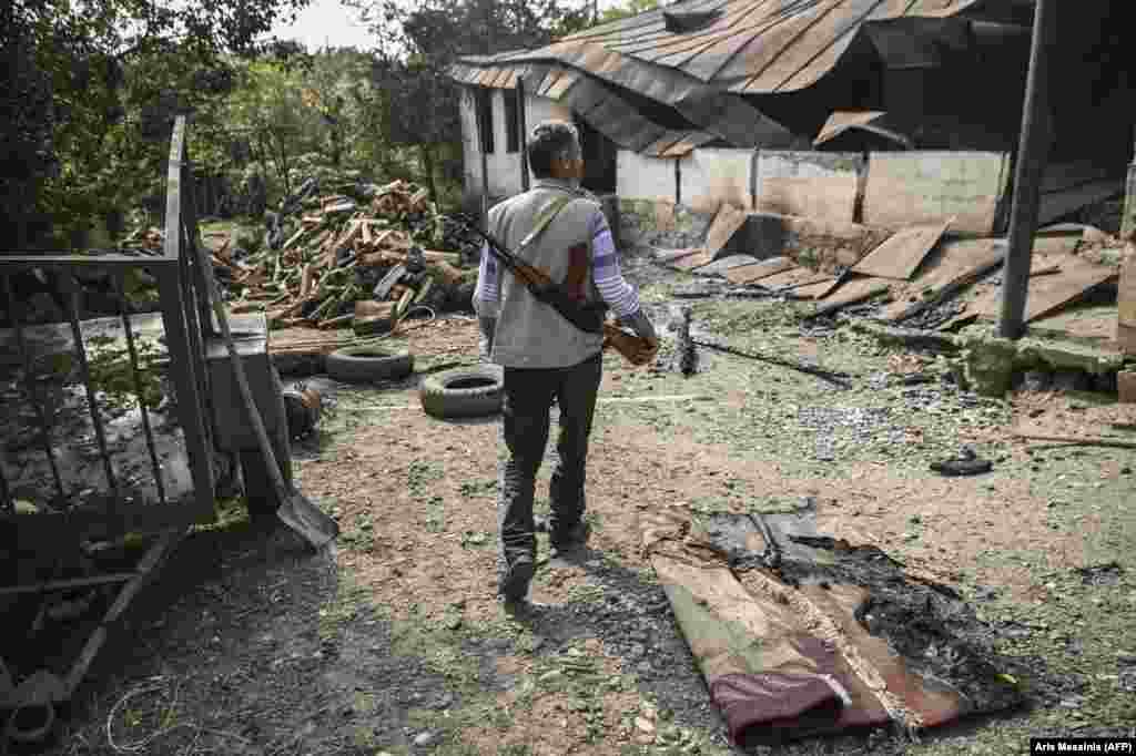 A villager arrives at a neighbor&rsquo;s destroyed home in the Martakert region of Nagorno-Karabakh on October 15.