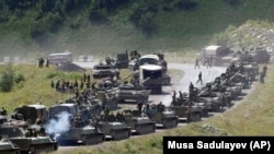 A column of Russian armored vehicles is seen on its way to the South Ossetian capital of Tskhinvali on August 9, 2008.