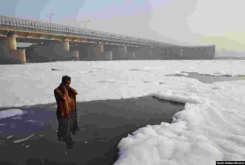 A Hindu devotee takes a ritual dip in the polluted Yamuna River in New Delhi on March 21, 2010.