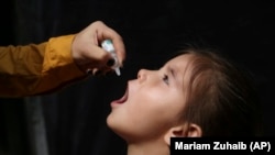 An Afghan girl is vaccinated during a polio-eradication campaign in Kabul on August 24.