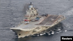 The Russian aircraft carrier Admiral Kuznetsov cruises in international waters off the northern coast of Norway on October 17.