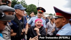 A woman shouts at police during a rally in Almaty, June 9, 2019.