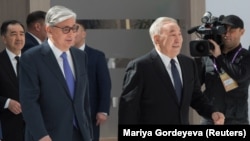 Then-interim President Qasym-Zhomart Toqaev (left) and former President Nursultan Nazarbaev attend the Astana Economic Forum in Nur-Sultan in May 2019.