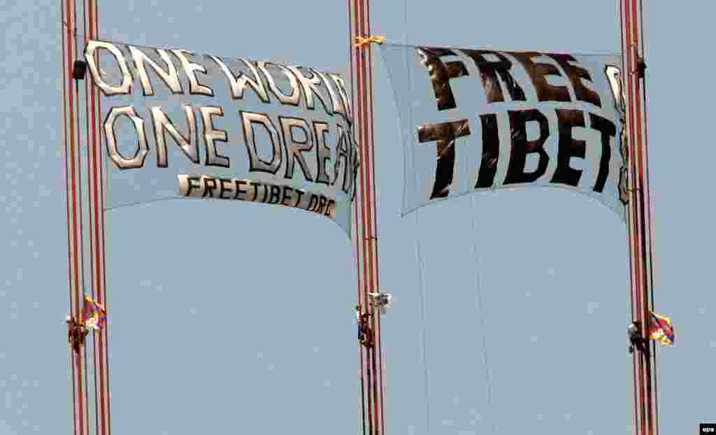 Three demonstrators scale the Golden Gate Bridge to unfurl two &quot;Free Tibet&quot; banners in San Francisco, California, where the torch relay took an undisclosed route, in April 2008.