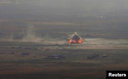 A car-bomb attack is seen to the east of Mosul during clashes with Islamic State militants on October 17.