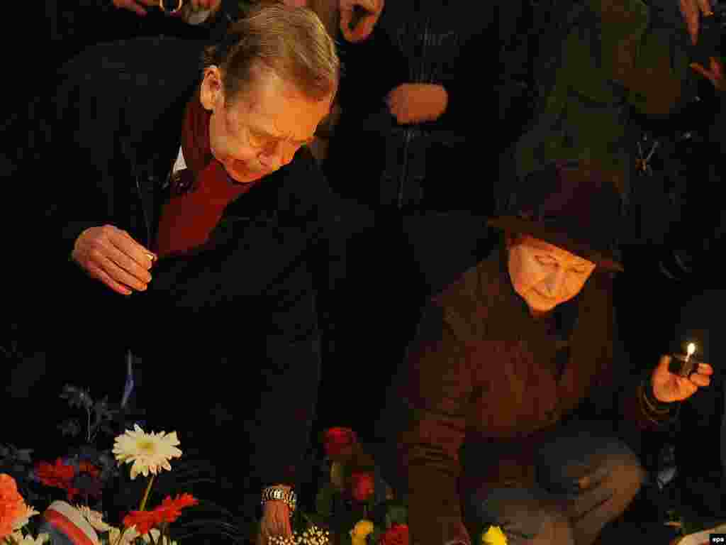 Havel (left) lights candles at the students&#39; memorial on National Avenue in Prague on November 17, 2009.