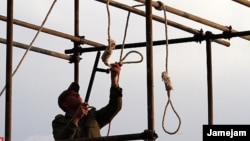 An Iranian soldier prepares a noose for a public hanging (file photo)