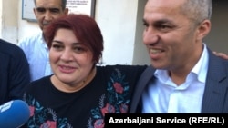 Khadija Ismayilova (left) talks to reporters upon her release from prison on May 25.