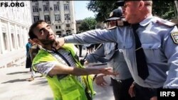 Aliyev is beaten by police at a protest rally in Baku in June 2013.