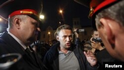 Blogger and activist Aleksei Navalny talks to police officers during a rally in central Moscow on May 8.