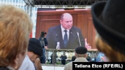 Prime Minister Valeriu Strelet is seen on a screen outside the parliament building in Chisinau as he speaks inside shortly before he was dismissed on October 29.