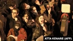 Iranian students chant slogans as they demonstrate following a tribute for the victims of Ukrainian airliner that was shot down over Tehran ion January 8. 