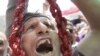 Egypt -- A man holds a noose as he shouts revenge slogans on Tahrir Square, Cairo, 22Jul2011