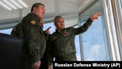 Russian Defense Minister Sergei Shoigu (center) and General Valery Gerasimov (left) observe military drills in Crimea on April 22.