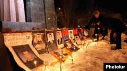 Pictures of opposition supporters killed in Yerevan in March 2008 are placed at the site of the deadly postelection unrest in March 2012. Opposition parties will watch for a clean vote.