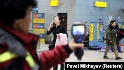 A Kazakh sanitary-epidemiological-service worker uses a thermal scanner to detect travelers from China who may have symptoms possibly connected with the coronavirus at Almaty International Airport on January 21.