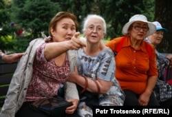 An older woman in Astana Square, Almaty, points towards police officers. June 10, 2019.