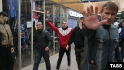 Groups of young men were said to have initiated the violence at a shopping center in the Moscow neighborhood of Biryulevo, smashing windows and overturning cars but apparently not causing any fatalities.