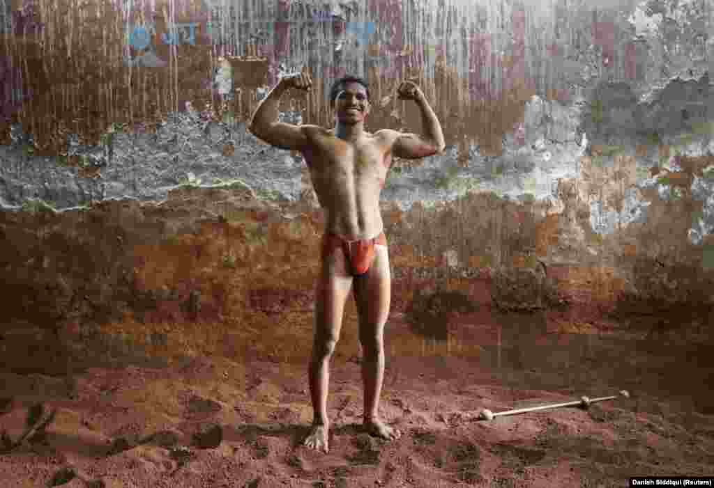 Deepak Mane, a 19-year-old wrestler, poses inside a traditional Indian wrestling center in Mumbai on March 24, 2014.&nbsp;