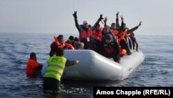 Syrian student Daoud Daoud (center, arms raised) was one of 4,000 new arrivals to the island of Lesbos during the last weekend in February. 