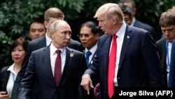 U.S. President Donald Trump (right) and Russian President Vladimir Putin talk during the Asia-Pacific Economic Cooperation summit in Vietnam on November 11.