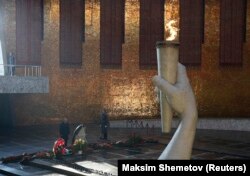 Putin attends a wreath-laying ceremony at the eternal flame at the Mamayev Kurgan memorial complex in Volgograd on February 2.