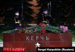 Flowers and candles are seen at a memorial by the Kremlin walls in Moscow to commemorate the victims.