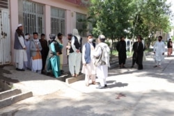 Relatives of the victims wait to claim the bodies on May 2.