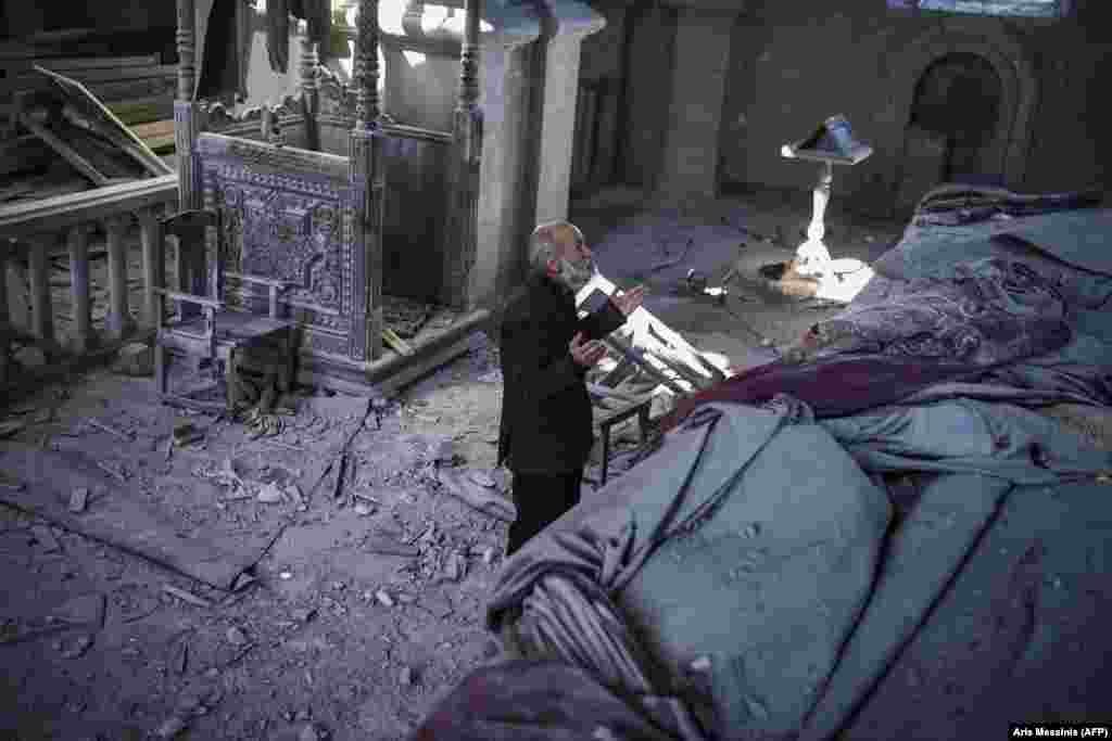 Arthur Sahakian, 63, prays inside the artillery-damaged Holy Savior Cathedral in Shushi, in Nagorno-Karabakh, on October 13.