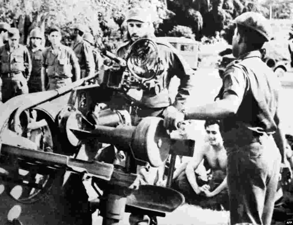 With tensions lingering despite the U.S.-Soviet deal, Cuban leader Fidel Castro (center) inspects weapons at a military base on November 2.