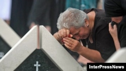 Relatives of Georgians killed in the August 2008 war take part in the memorial ceremony at the cemetery in Tbilisi.