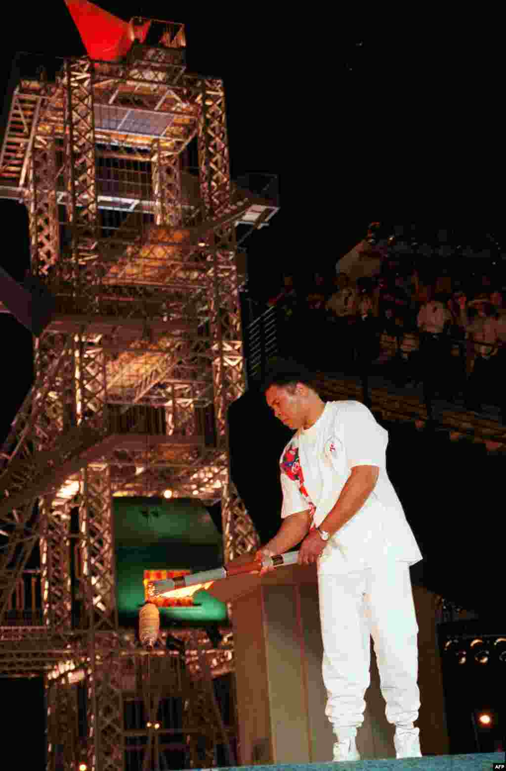 Former heavyweight boxing champion and 1960 Olympic gold medalist Muhammad Ali lights the flame at the Olympic Stadium in Atlanta in July 1996.