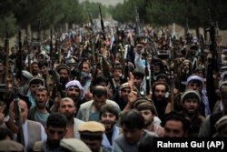 Militiamen join Afghan security forces during a gathering in Kabul on June 23.