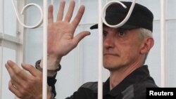 Platon Lebedev gestures inside the defendants' box during a 2011 court hearing.