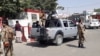 Afghan security forces stand guard at the entrance gate of Hamid Karzai International Airport in Kabul on August 15.